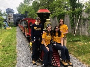 zoo students posing in front of the train